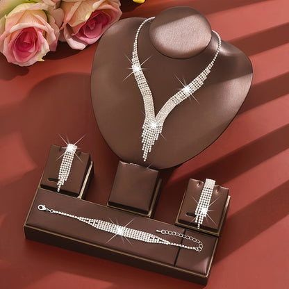 A Stylish Silvery Jewelry Set Adorned with Rhinestones, Including a Necklace, a Pair of Earrings, And a Bracelet, Perfect for Accessories at Balls And Parties.
